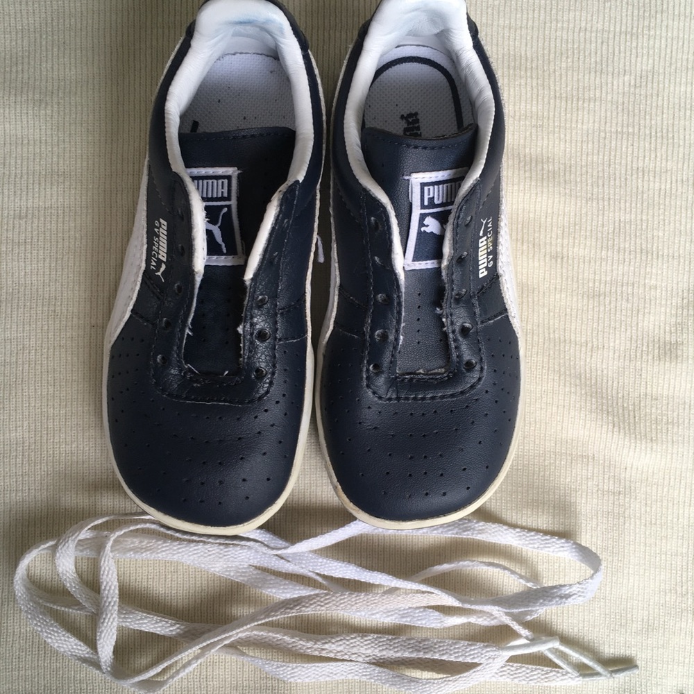 Boy’s navy blue and white Puma tennis shoes